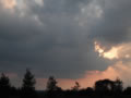 Sun behind storm clouds